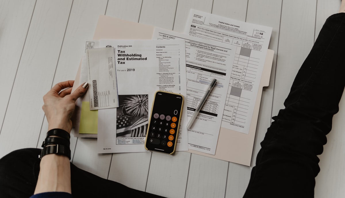Business owners reviewing cash-flow documents and a calculator